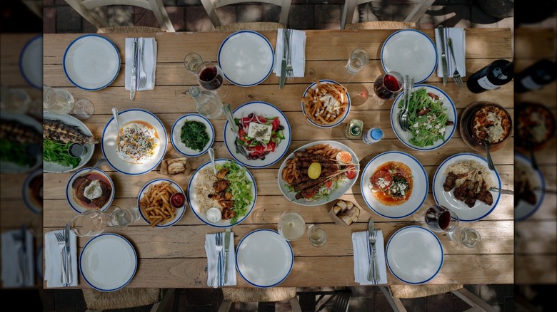 Plated wood table with several Greco-Turkish dishes