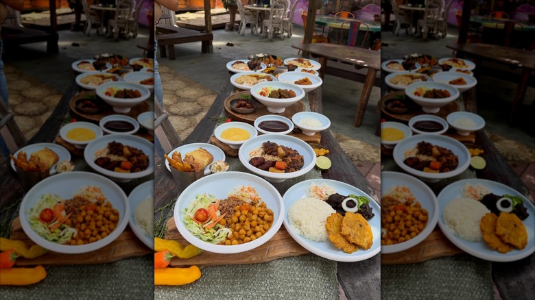 Several Haitian dishes plated on a long table