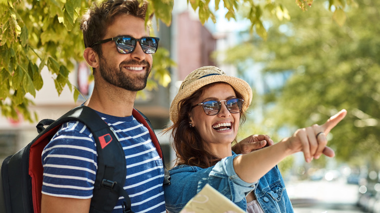 People wearing sunglasses, pointing and exploring town