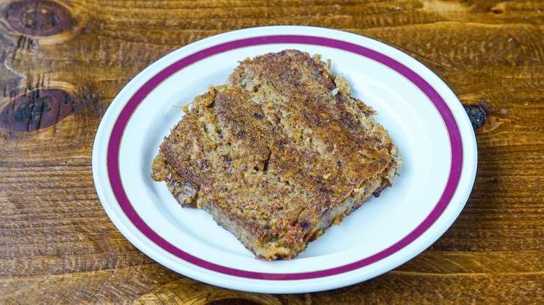 A slice of scrapple, a Pennsylvania Dutch dish, on a plate.