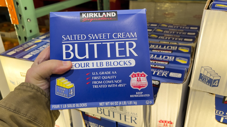 person holding kirkland signature sweet cream butter