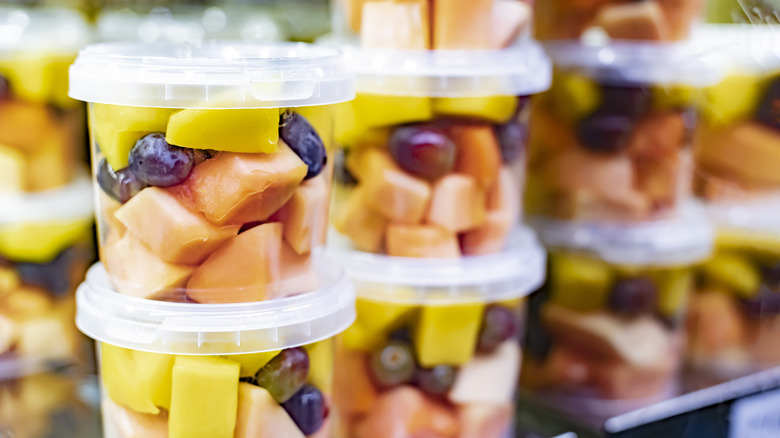 precut fruit in clear container stacked on shelf