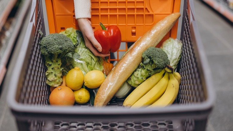 woman placing groceries in cart