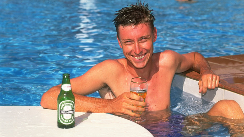 Man enjoying a Heineken poolside