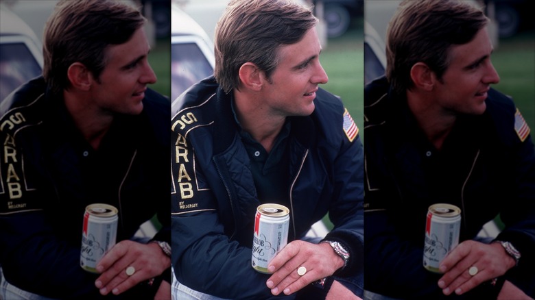 A man holds a Michelob can