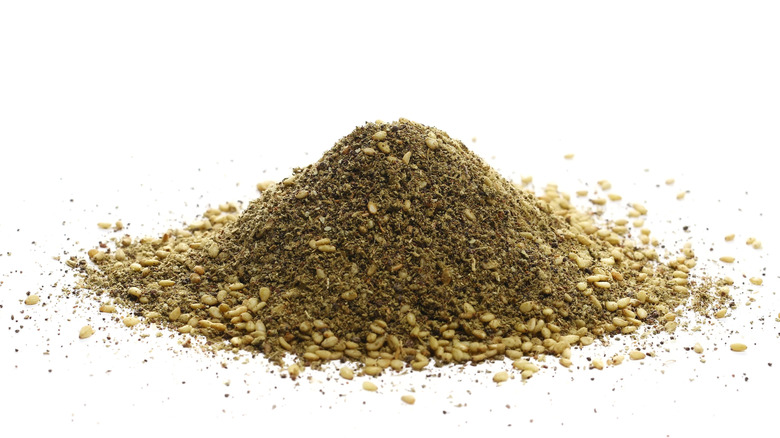 A pile of za'atar seasoning isolated on a white background