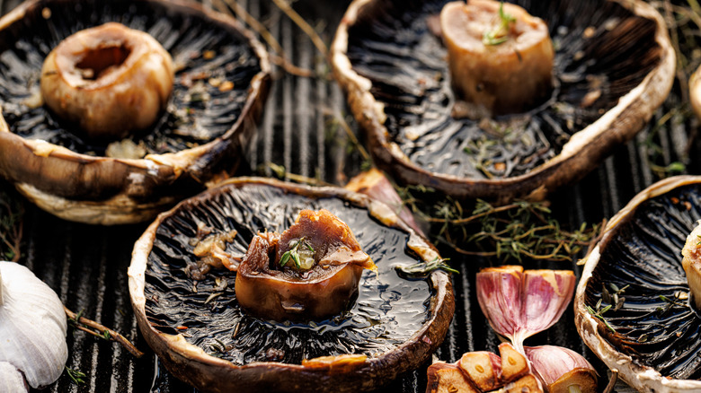 Grilled portobello mushrooms with herbs and garlic on a grill plate