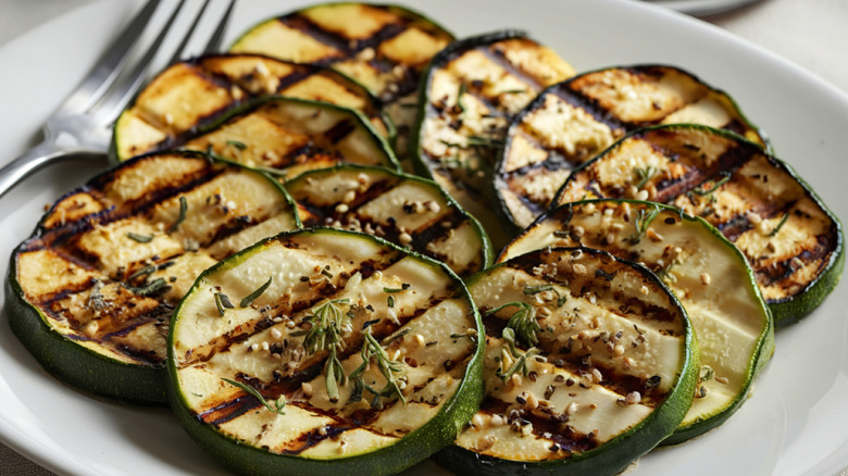 A photo of a plate of grilled zucchini slices