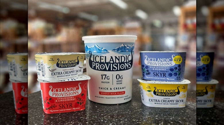 Icelandic provisions yogurts on display with blurred grocery store in background