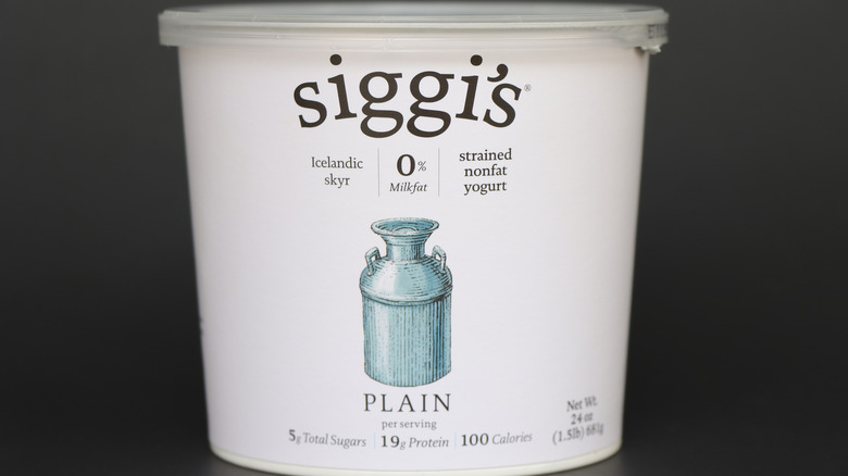 White container of siggi's Icelandic skyr plain yogurt on gray background