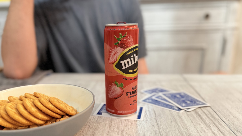 Mike's Hard Lemonade with cards and snacks on a table
