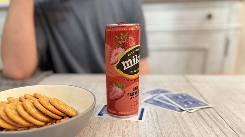 Mike's Hard Lemonade with cards and snacks on a table