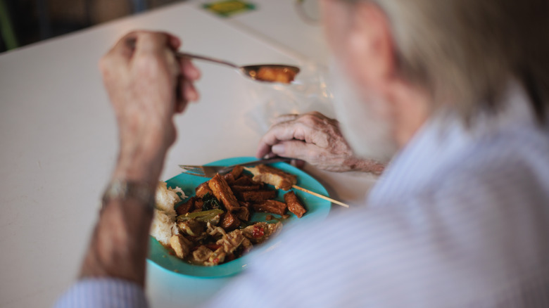 person eating plate of food