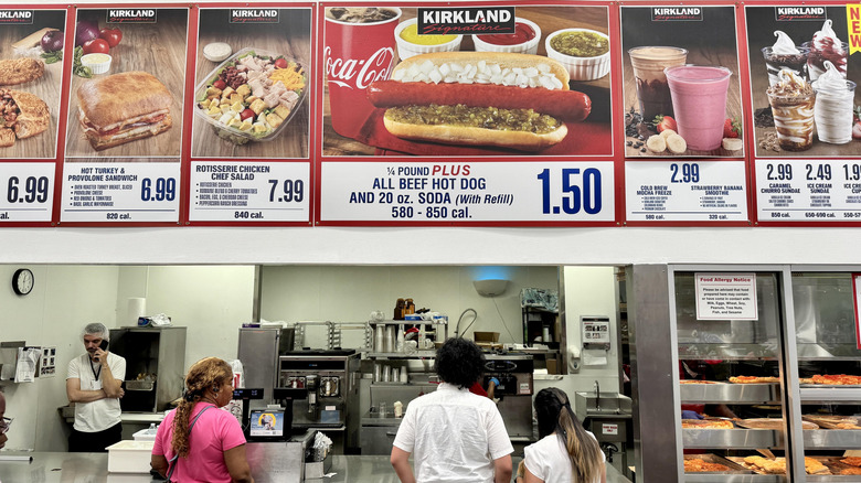 A Costco food court with customers ordering at the counter.