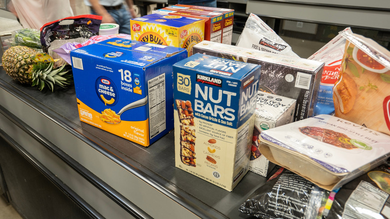 A Costco checkout conveyor belt covered with items.