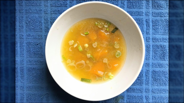 Bowl of kabocha squash soup on blue towel