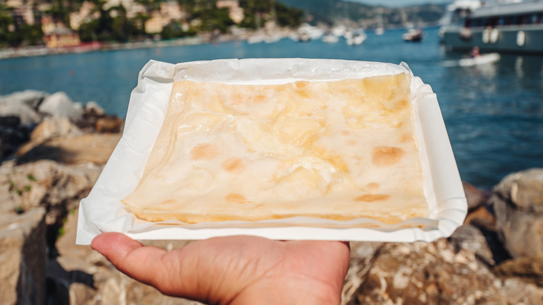Focaccia di Recco in front of Ligurian Sea