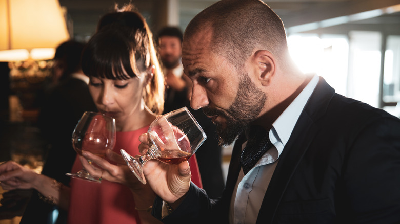 Couple sniffing whiskey