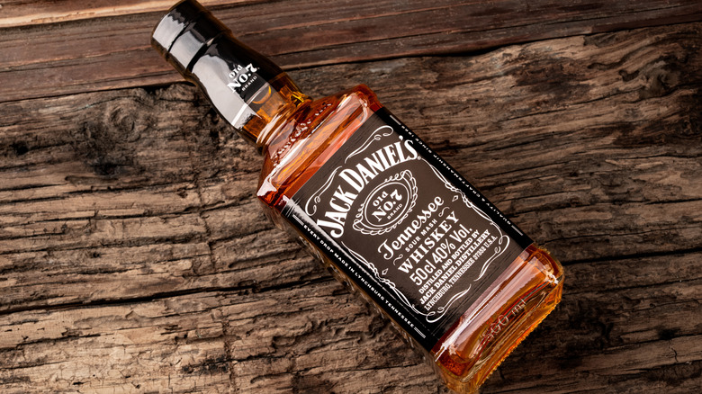 A bottle of Jack Daniel's Old No. 7 Tennessee Whiskey on a wooden surface.