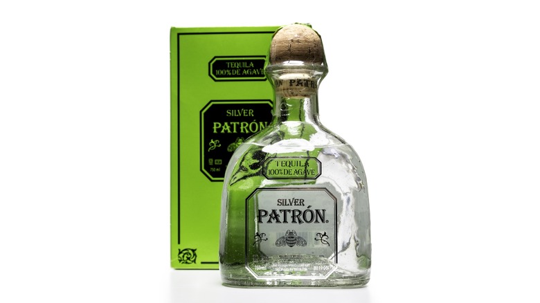 A bottle of Patron Silver with its lime green box behind it.