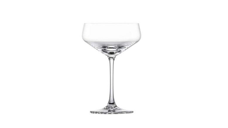 A coupe drinking glass in front of a white background
