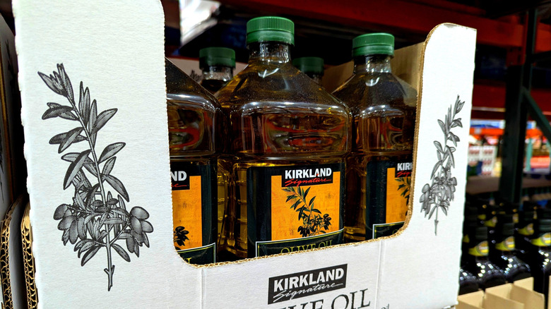 Kirkland Signature Olive Oil in plastic jugs on Costco shelf
