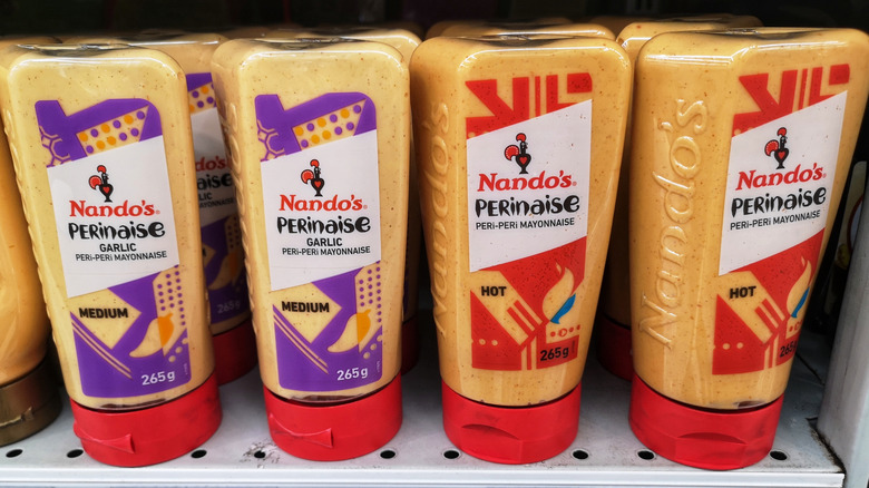 Nando's Perinaise bottles lined up on store shelf