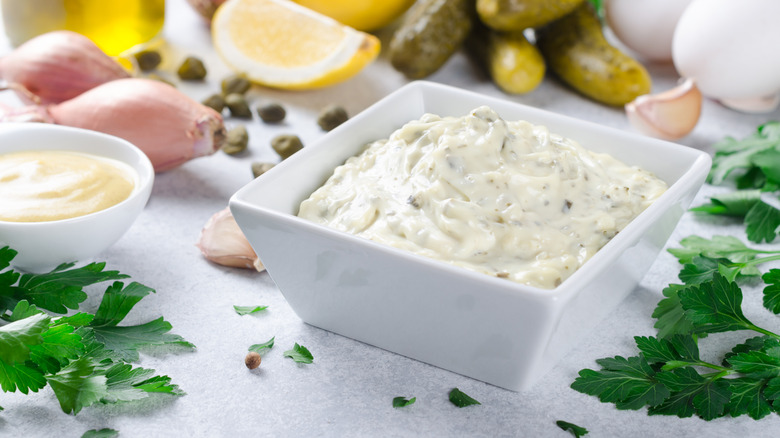 French remoulade in white ramekin surrounded by ingredients