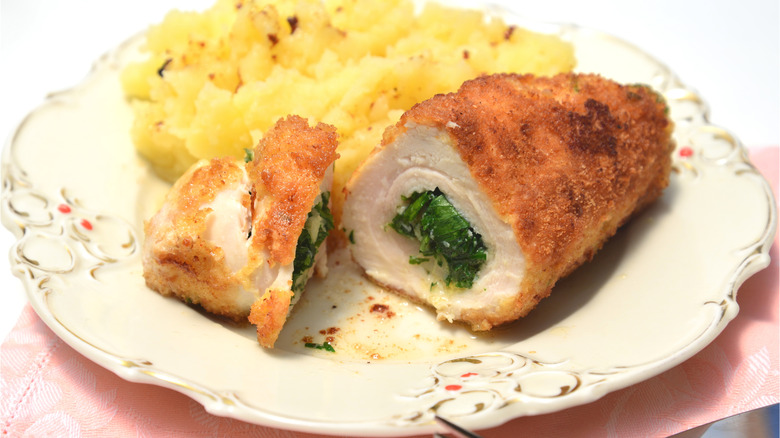 Chicken kiev on plate with potatoes