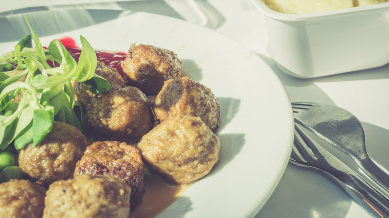 Retro-style shot of swedish meatballs on plate with fork