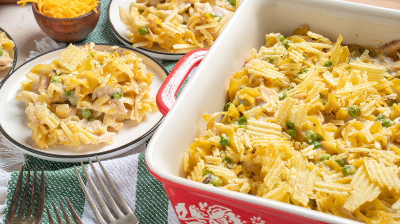 Casserole dish and plates of tuna casserole