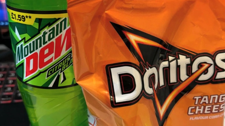 Bottle of Mountain Dew by bag of Doritos