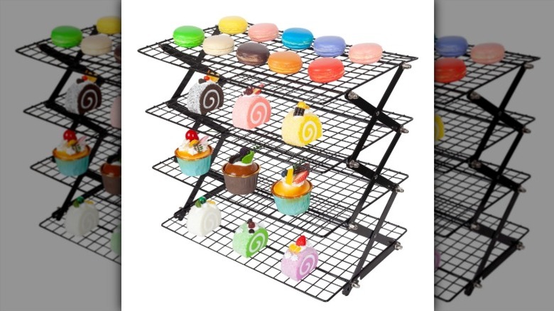 A Akraf collapsible cooling rack standing up on a white background.