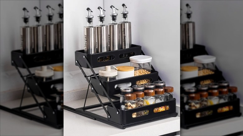 Vusign foldable spice rack filled with spice jars and dispensing cruets sitting on a kitchen counter.