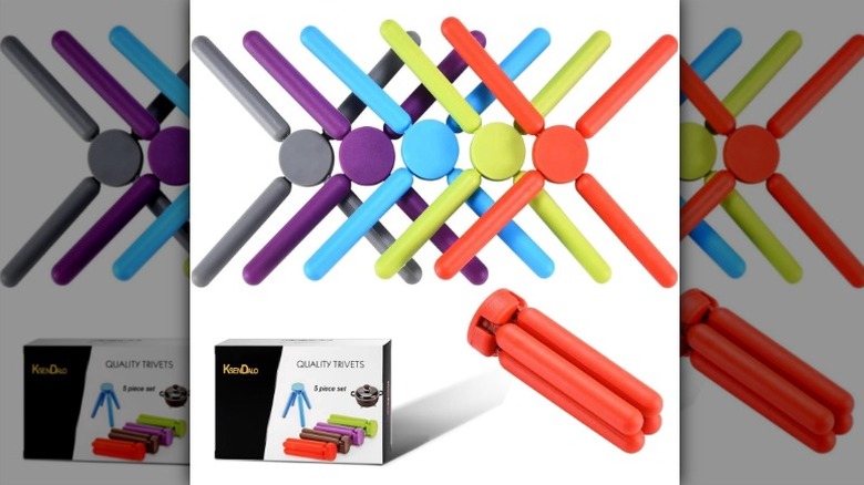 Ksendalo foldable silicone trivets along with the box they came in on a white background.