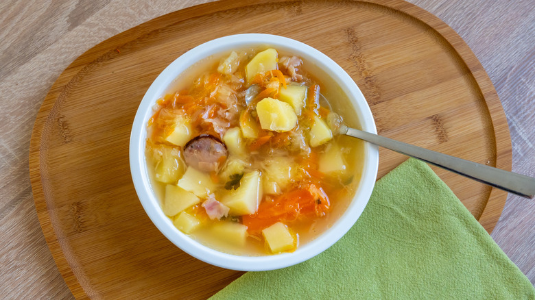 Bowl of kapusniak with spoon and napkin