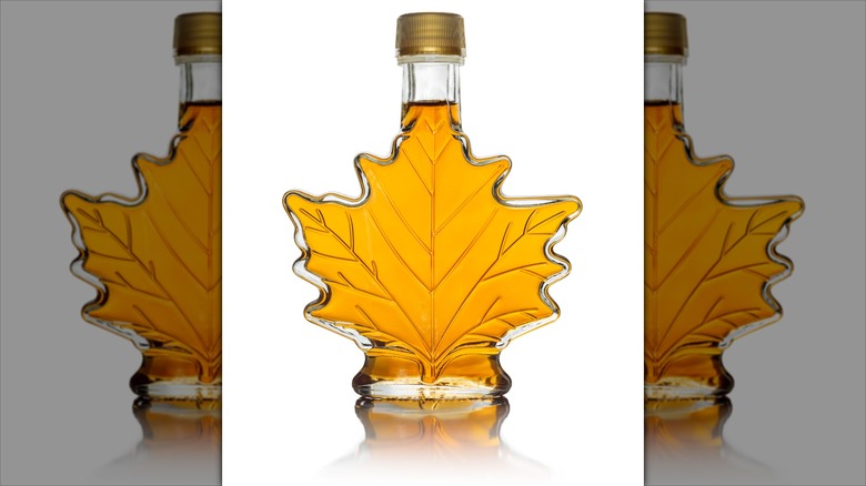 Maple leaf-shaped glass bottle of maple syrup