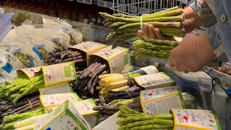 Fresh asparagus selection at market displayed in various colors