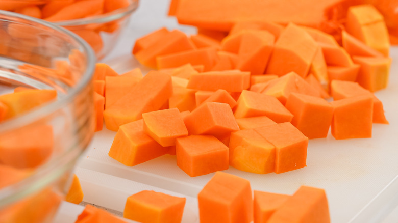 cubed butternut squash on a white cutting board