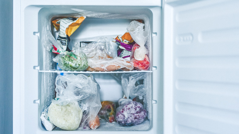 Plastic-wrapped items in an open freezer