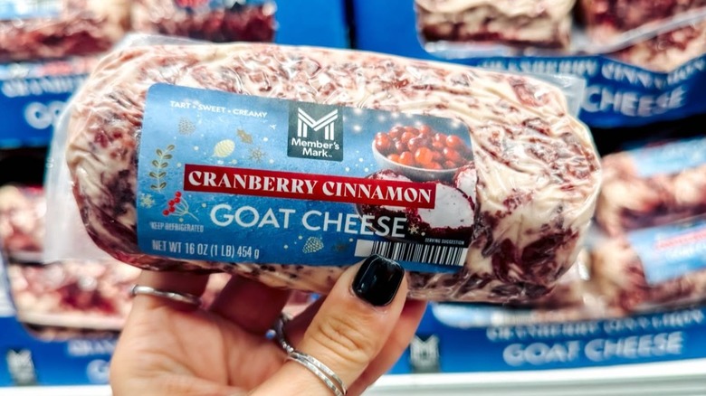 Someone holding a tube of Maker's Mark flavored goat cheese.
