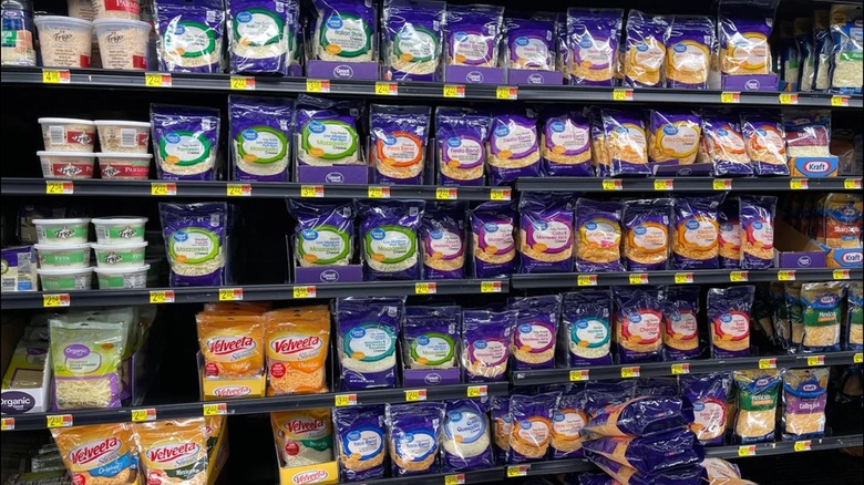 Five vertical rows of cheese inside a Walmart.