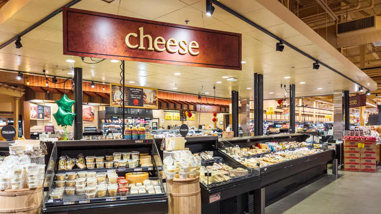 A well-lit Wegmans cheese section.