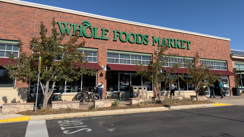 An all brick Whole Foods Market with green letters and a maroon awning