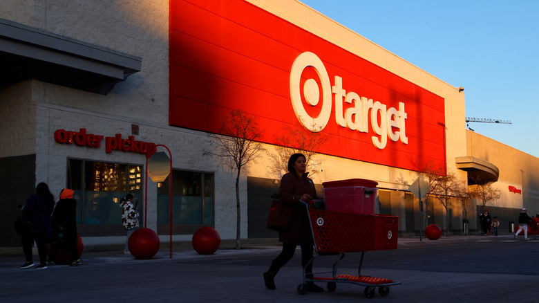 Woman pushing a full shopping cart in front of a Target