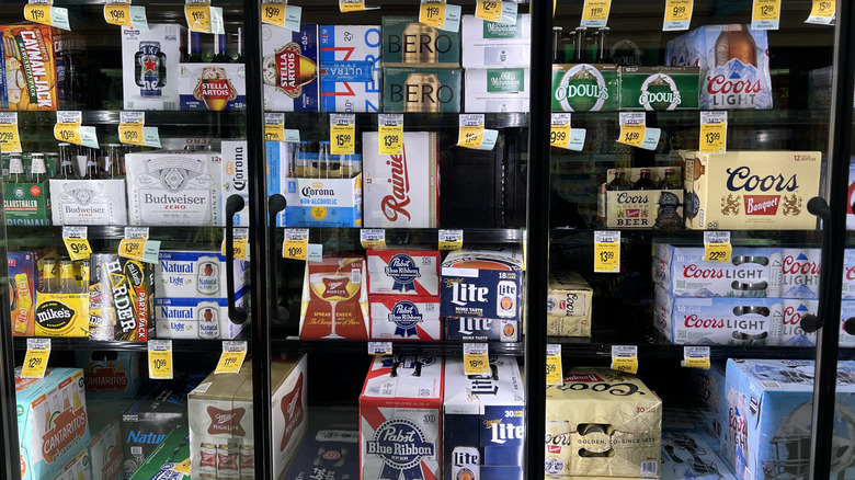 A variety of beer for sale in a grocery store cooler