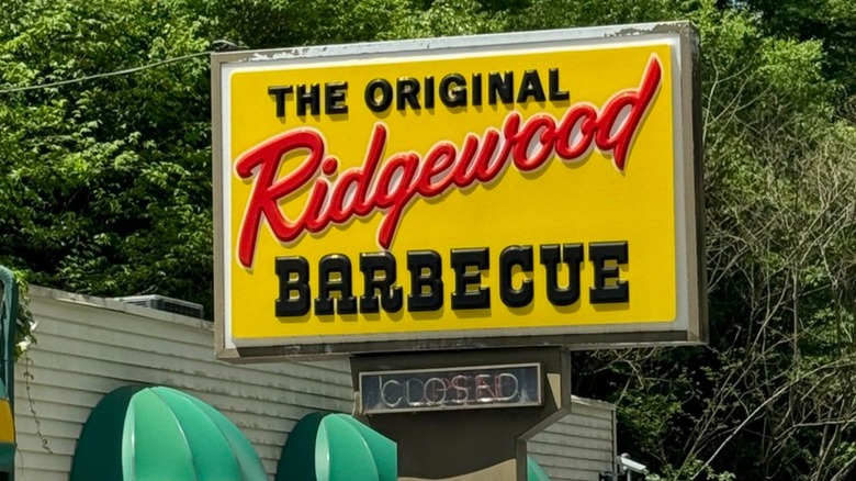 The exterior of the Original Ridgewood Barbecue with its sign and cars parked out front