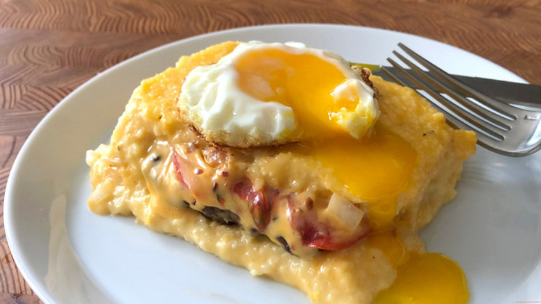 Cheeseburger grits casserole on a plate with a fork