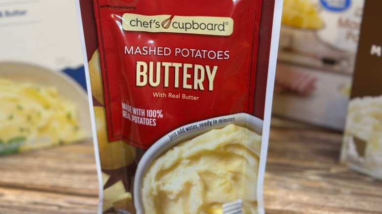 Chef's Cupboard Mashed Potatoes Buttery in focus with other brands in background