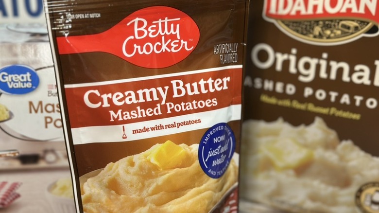 Betty Crocker Creamy Butter Mashed Potatoes in forground against other mashed potato products